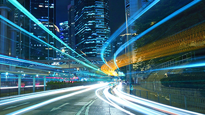 A timelapse photo on a city street with light trails