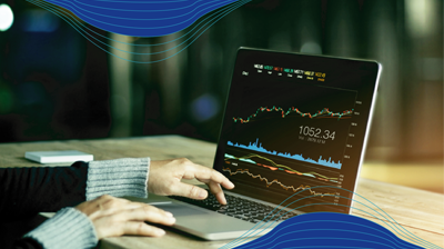 Hands using a laptop to review analytics 